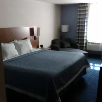 a hotel room with a bed and a couch at Mainstreet Inn in Doylestown