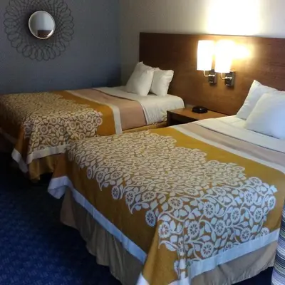 a hotel room with two beds and a mirror at Mainstreet Inn in Doylestown