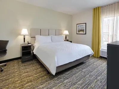 a hotel room with a large bed and a window at Candlewood Suites Philadelphia - Airport Area by IHG in Chester