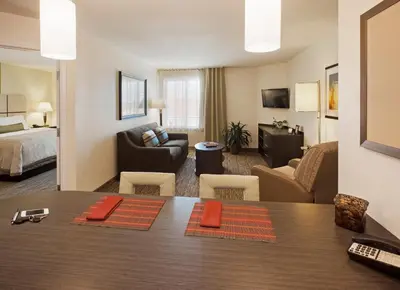 a hotel room with a dining table and a living room at Candlewood Suites Philadelphia - Airport Area by IHG in Chester