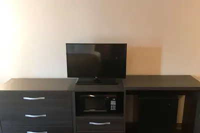 a desk with a microwave and a television on it at Econo Lodge Mifflintown in Mifflintown