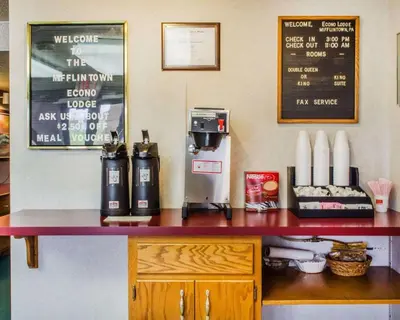 a counter with a coffee maker and a cash register at Econo Lodge Mifflintown in Mifflintown