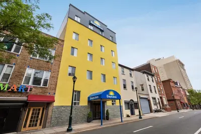 a yellow building on the side of a street at Days Inn by Wyndham Philadelphia Convention Center in Philadelphia