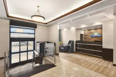 a salon with a waiting room with a sign on the wall at Days Inn by Wyndham Philadelphia Convention Center in Philadelphia