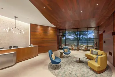 a lobby with chairs and tables and a counter at Homewood Suites By Hilton Wilmington Downtown in Wilmington