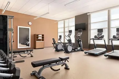 a gym with several treadmills and exercise bikes at Homewood Suites By Hilton Wilmington Downtown in Wilmington