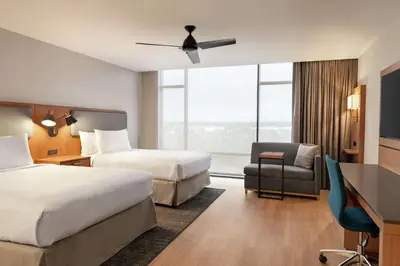 a hotel room with two beds and a desk and a chair at Homewood Suites By Hilton Wilmington Downtown in Wilmington