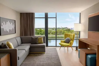 a living room with a couch and a yellow chair at Homewood Suites By Hilton Wilmington Downtown in Wilmington