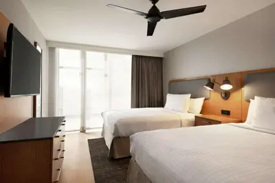 a hotel room with two beds and a flat screen tv at Homewood Suites By Hilton Wilmington Downtown in Wilmington