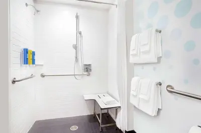 a white bathroom with a shower and a sink at Tru By Hilton Audubon Valley Forge in Audubon