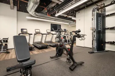 a gym with treadmills and exercise bikes in it at Motto by Hilton Philadelphia Rittenhouse Square in Philadelphia