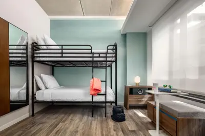 a bedroom with two bunk beds and a desk at Motto by Hilton Philadelphia Rittenhouse Square in Philadelphia