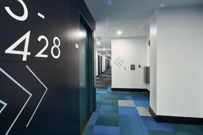 a hallway of an office with a wall with the number at Motto by Hilton Philadelphia Rittenhouse Square in Philadelphia