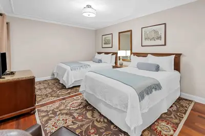 a hotel room with two beds and a flat screen tv at Penn's View Hotel Philadelphia in Philadelphia