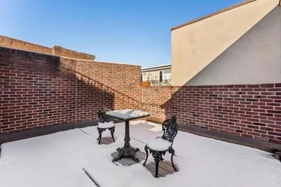 a snow covered patio with two chairs and a table at Penn's View Hotel Philadelphia in Philadelphia