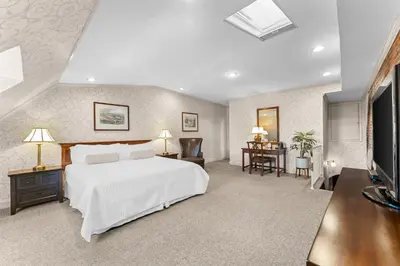 a bedroom with a white bed and a desk at Penn's View Hotel Philadelphia in Philadelphia