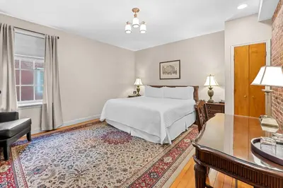 a bedroom with a bed and a desk and a chair at Penn's View Hotel Philadelphia in Philadelphia