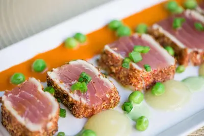 a plate of food with meat and green onions on it at The Desmond Hotel Malvern, a DoubleTree by Hilton in Malvern