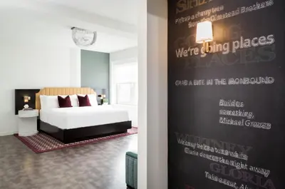 a bedroom with a bed and a wall with writing on it at TRYP by Wyndham Newark Downtown in Newark