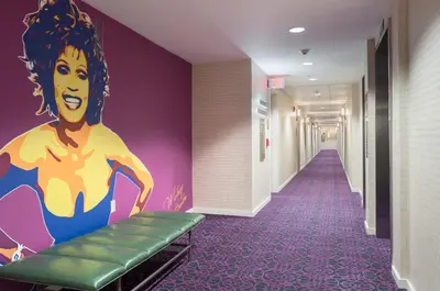 a corridor in a hospital with a painting on the wall at TRYP by Wyndham Newark Downtown in Newark