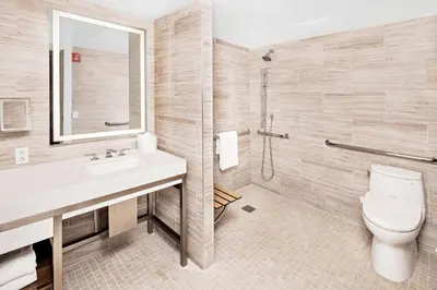 a bathroom with a toilet and a sink and a shower at Hilton Club The Quin New York in New York