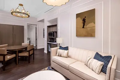 a living room with a couch and a dining room at Hilton Club The Quin New York in New York