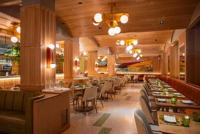 a restaurant with tables and chairs in a room at Hilton Club The Quin New York in New York