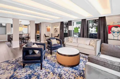 a living room with a couch and chairs and a table at Hilton Club The Quin New York in New York
