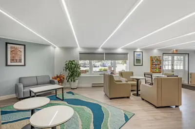 a waiting room with couches and tables and chairs at Quality Inn Smoketown - Lancaster Area in Smoketown