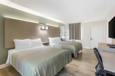 a hotel room with two beds and a television at Quality Inn Smoketown - Lancaster Area in Smoketown
