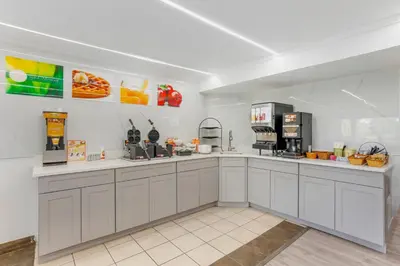 a large kitchen with white cabinets and appliances at Quality Inn Smoketown - Lancaster Area in Smoketown