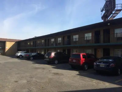 a row of cars parked in front of a building at Hudson Plaza Motel Bayonne Jersey City in Jersey City