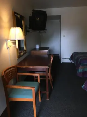a room with a desk and a chair and a bed at Hudson Plaza Motel Bayonne Jersey City in Jersey City