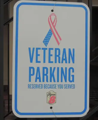 a sign that says veteran parking with a red ribbon at Super 8 by Wyndham Mifflinville Near Bloomsburg in Mifflinville