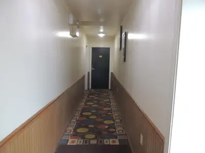 a hallway in a hospital with a carpet on the floor at Super 8 by Wyndham Mifflinville Near Bloomsburg in Mifflinville