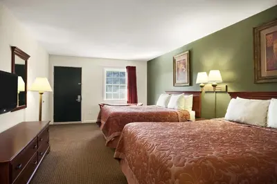 a hotel room with two beds and a flat screen tv at Super 8 by Wyndham Mifflinville Near Bloomsburg in Mifflinville