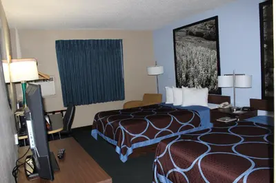 a hotel room with a bed and a flat screen tv at Super 8 by Wyndham East Stroudsburg - Poconos in East Stroudsburg