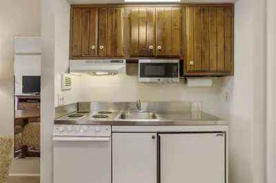 a kitchen with a sink and a microwave at Best Western PLUS Morristown Inn-Florham Park in Morristown