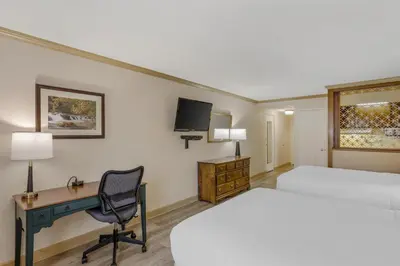 a hotel room with two beds and a desk and a computer at Best Western PLUS Morristown Inn-Florham Park in Morristown