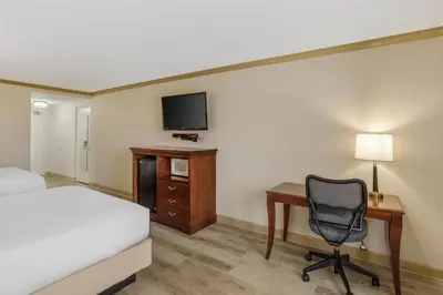 a hotel room with a bed and a desk and a chair at Best Western PLUS Morristown Inn-Florham Park in Morristown