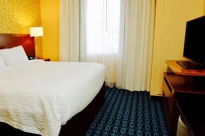 a hotel room with a large bed and a television at Fairfield by Marriott Inn & Suites Jonestown Lebanon Valley in Jonestown