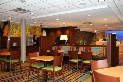 a restaurant with tables and chairs and a counter at Fairfield by Marriott Inn & Suites Jonestown Lebanon Valley in Jonestown