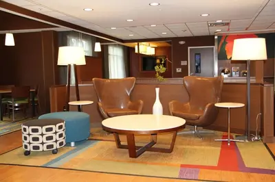 a waiting room with chairs and a table and a counter at Fairfield by Marriott Inn & Suites Jonestown Lebanon Valley in Jonestown