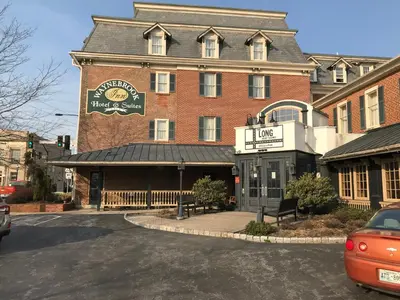 a large red brick building with a sign on it at Waynebrook Inn in Honey Brook