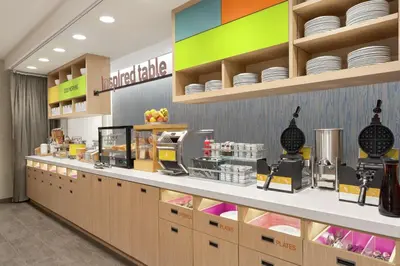 a food counter in a store with plates on shelves at Home2 Suites By Hilton Harrisburg Hershey in Harrisburg