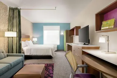 a hotel room with a bed and a television at Home2 Suites By Hilton Harrisburg Hershey in Harrisburg