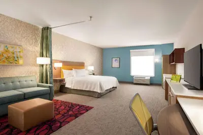 a large hotel room with a bed and a television at Home2 Suites By Hilton Harrisburg Hershey in Harrisburg