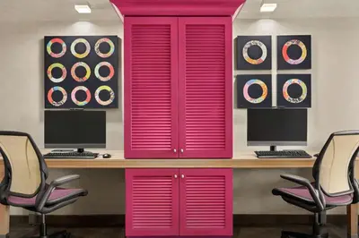 a pink office cubicle with two computer monitors on a desk at Home2 Suites By Hilton Harrisburg Hershey in Harrisburg
