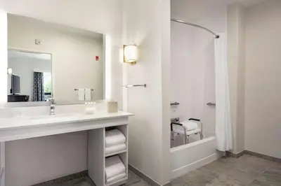 a bathroom with a sink and a mirror and a shower at Homewood Suites By Hilton Horsham Willow Grove in Horsham