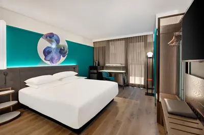 a bedroom with a white bed and a blue wall at Hyatt Centric Midtown 5th Avenue New York in New York